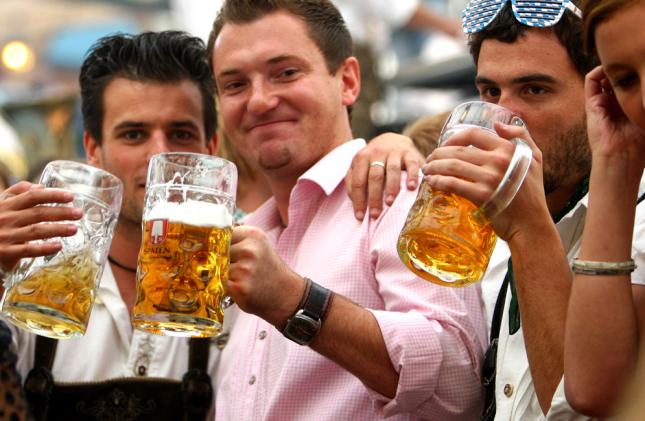 MUNICH, GERMANY - SEPTEMBER 20: Young people celebrates drinking beer at the Schottenhamel beer tent during day 1 of the Oktoberfest beer festival on September 20, 2008 in Munich, Germany. The Oktoberfest is seen as the biggest beer festival worldwide. (Photo by Johannes Simon/Getty Images)