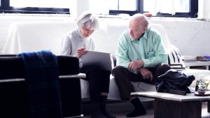 Senior adults working together learning how to operate their digital tablet