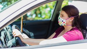 Millennial Female Wearing Face Mask in Car