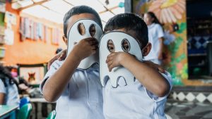 Portrait of child boys wearing ghost mask at school