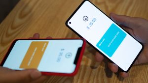 Asian man using smartphone to transfer money