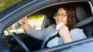 Cheerful obese woman getting her driver's license