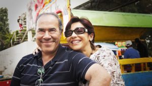Hispanic couple smiling at amusement park