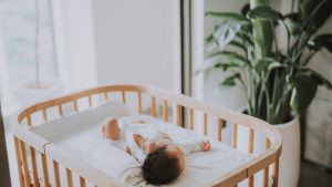An Asian newborn baby sleeping in the crib at home