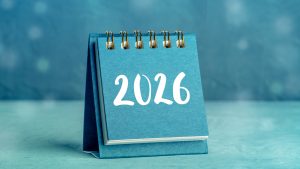 2026 Calendar. A desk calendar for the next year, shot on a blue background