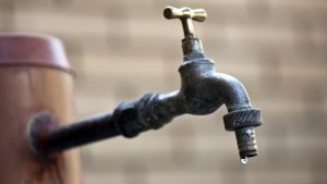 Last drop of water of an old faucet