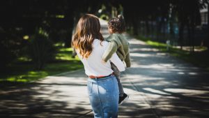 A young Jewish mother with her young boy, walking away from the camera