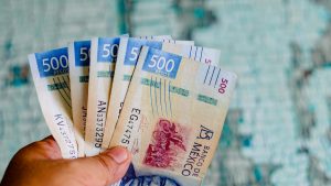 Two thousand five hundred Mexican pesos on a wooden table, banknotes