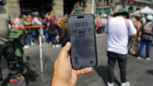 A person shows the cell phone  earthquake alert during the