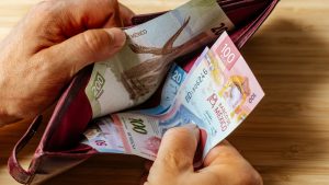 Hand takes money out of wallet, Mexico Peso banknotes, Concept, rising prices, value of Mexican currency