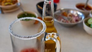 Michelada Mexican drink of beer, tomato juice, lemon and salt. With space for text.