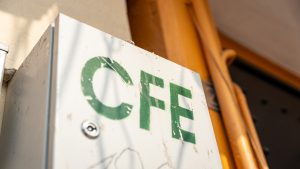 Logotype of the CFE (Federal Electricity Commission) on an electric energy meter box at a house.