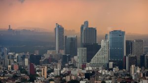 Smog hangs at dusk over downtown Mexico City