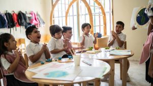 Students applauding a presentation by a schoolgirl in the classroom at school