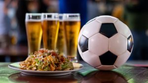 Food and drinks at a sports bar showing a football match