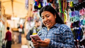 Mature woman using mobile phone at store