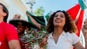 Mexican young woman celebrating with friends outdoors